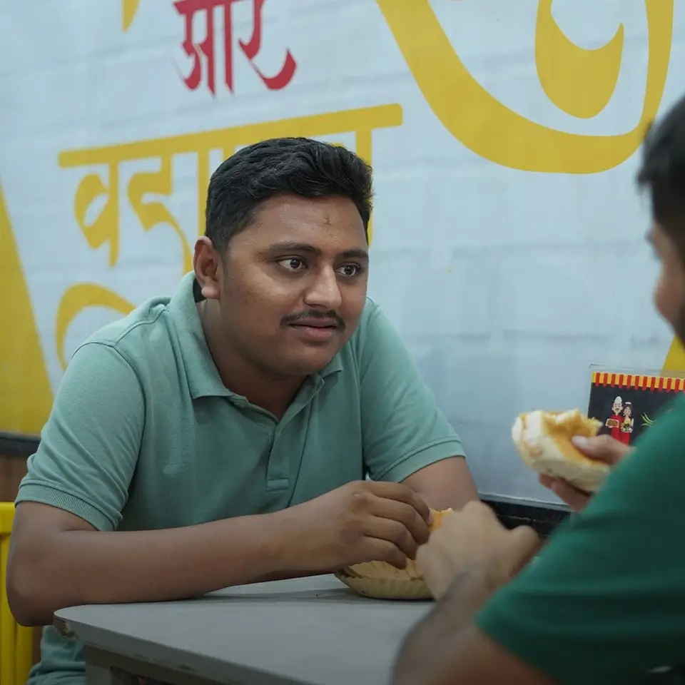 person eating vadapav at mmv outlet