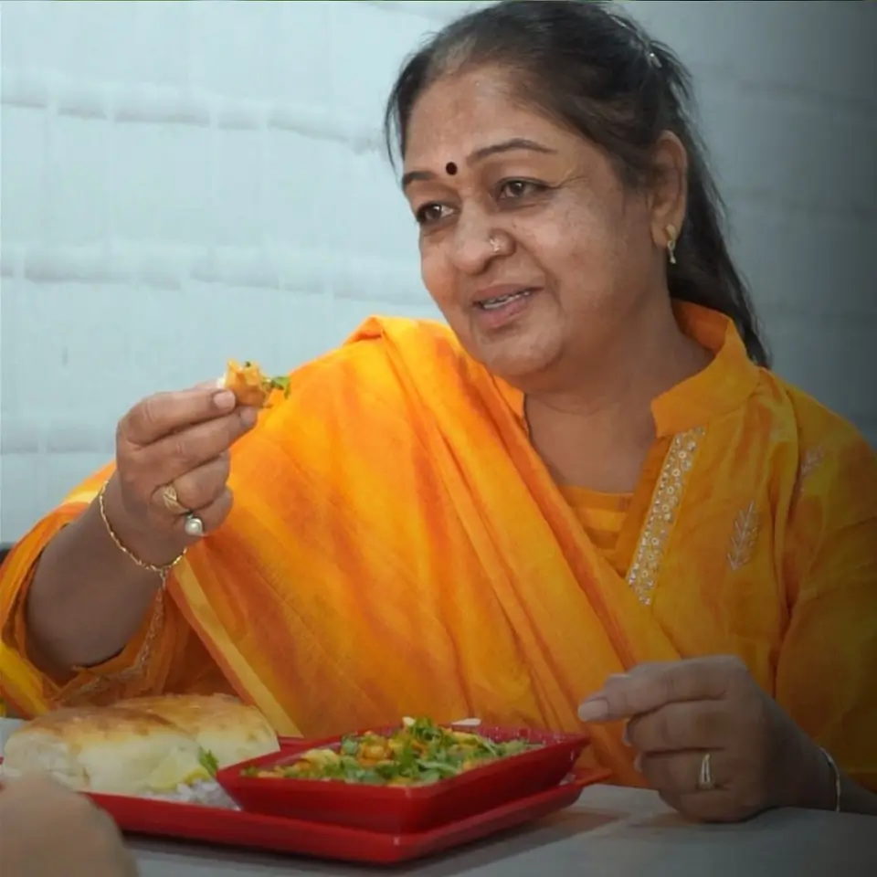woman having pav bhaji at mmv mumbiaya